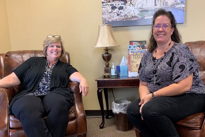 Two women sitting in armchairs.