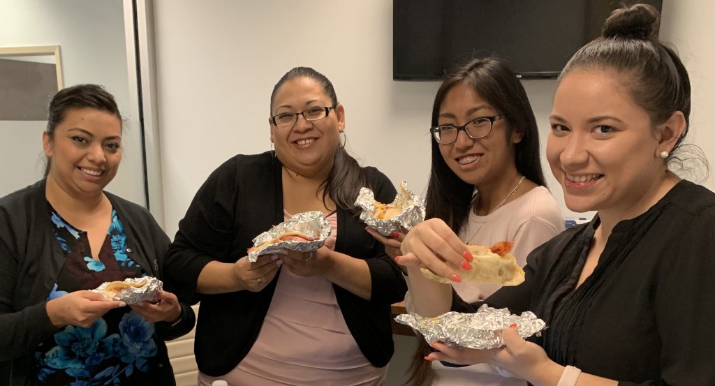 Group enjoying tacos together.