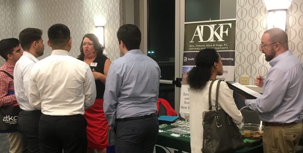Networking event with attendees and booth