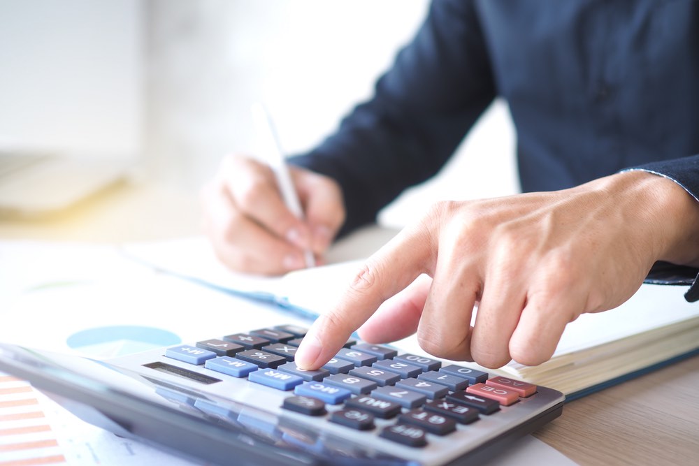 Person using calculator for calculations