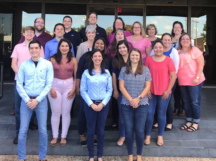 Group photo of staff members outdoors.