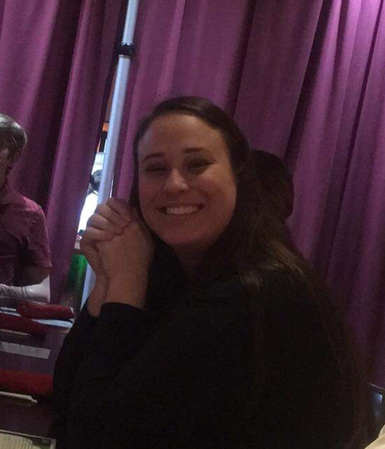 Person sitting at a table, engaged.