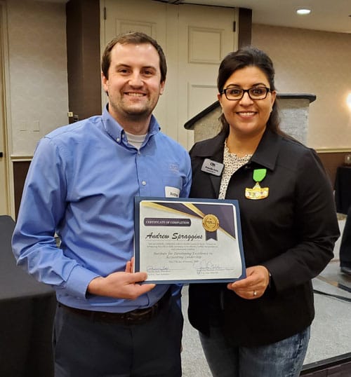 Certificate presentation at a formal event.