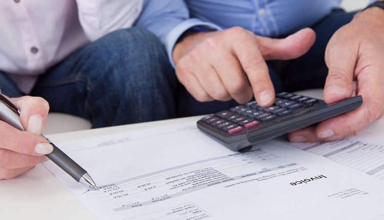 Calculating taxes with documents and calculator.