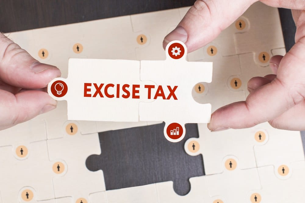 Hands holding puzzle piece labeled 'Excise Tax'