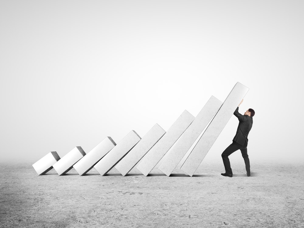 Businessman pushing upward growth bars