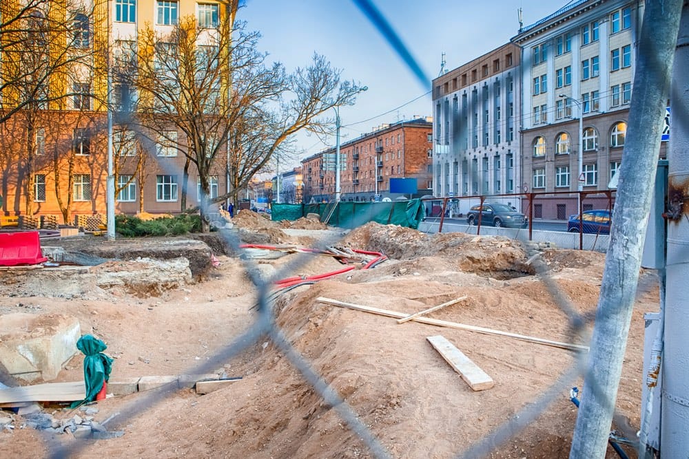 Construction site behind a fence.