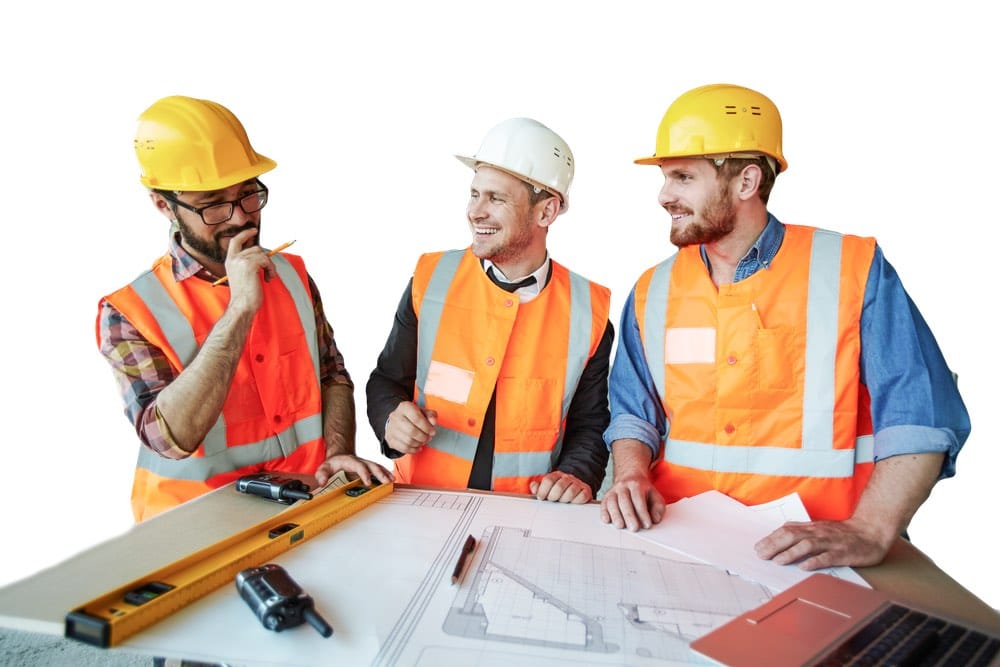 Three construction workers discussing plans.