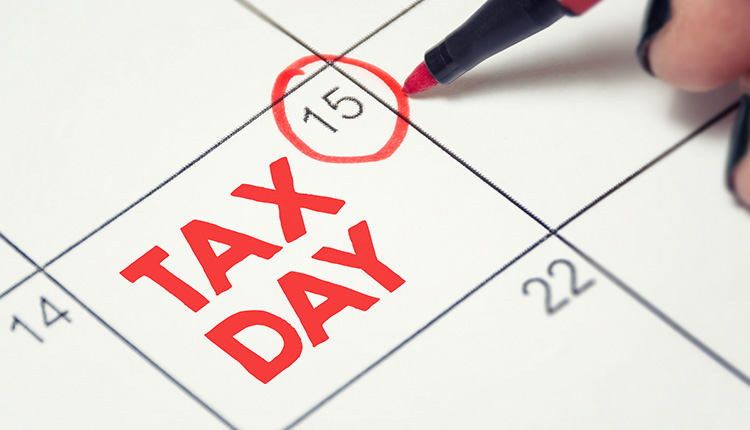 Marked calendar with 'Tax Day' highlighted.