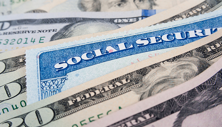 Social Security card with dollar bills