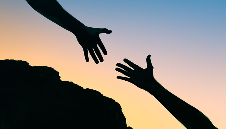 Two hands reaching towards each other