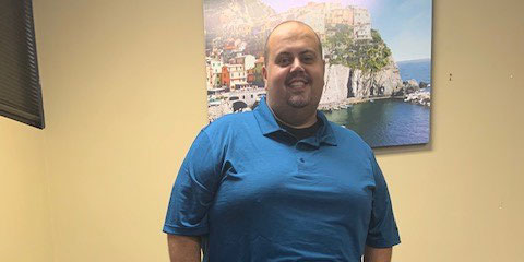 Person in blue shirt indoors.