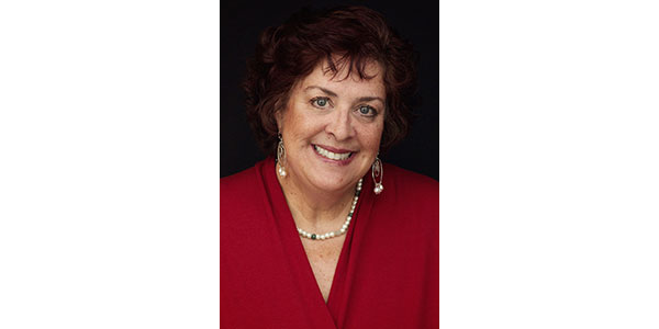 Woman in red attire with necklace.