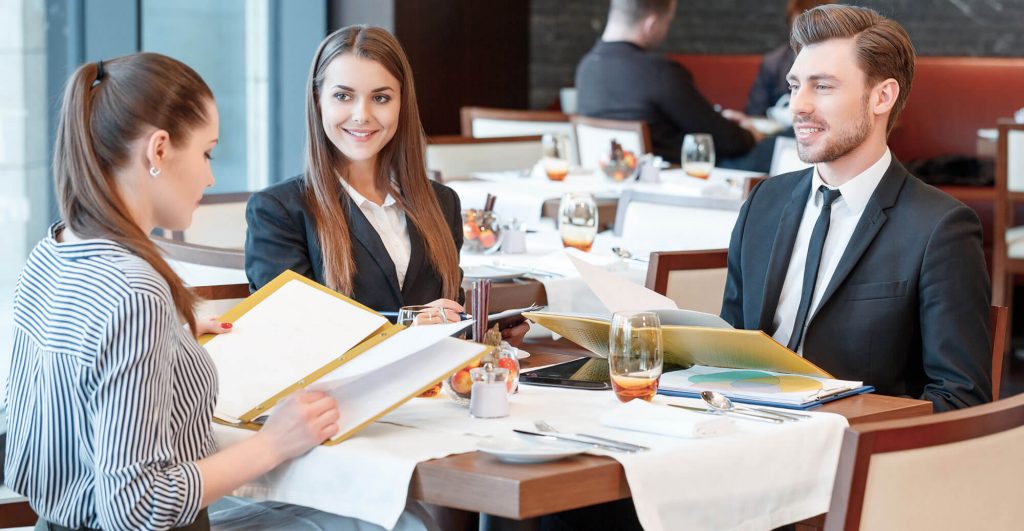 Business meeting at a restaurant table.
