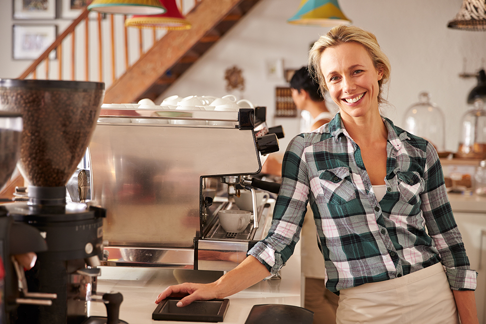 Woman in cafe with coffee machine