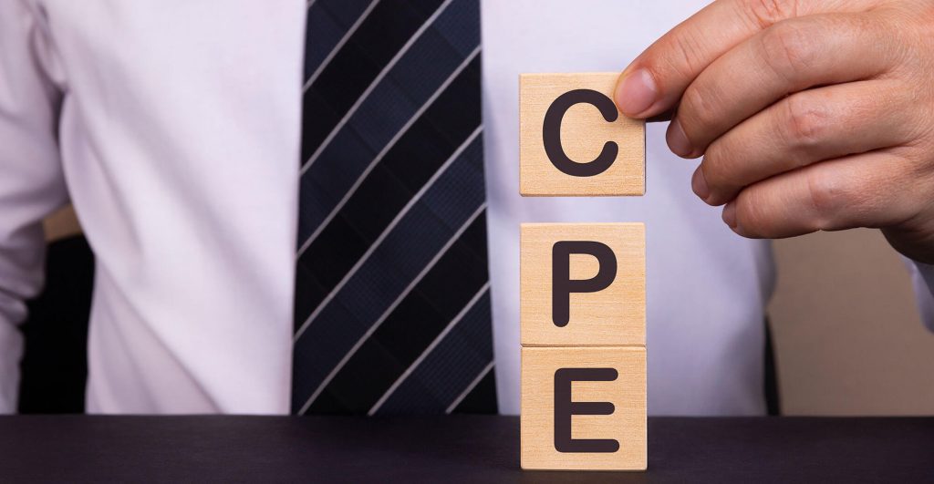 Hand holding wooden blocks spelling CPE