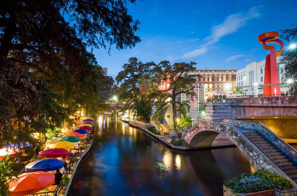 Colorful riverwalk with vibrant nightlife.