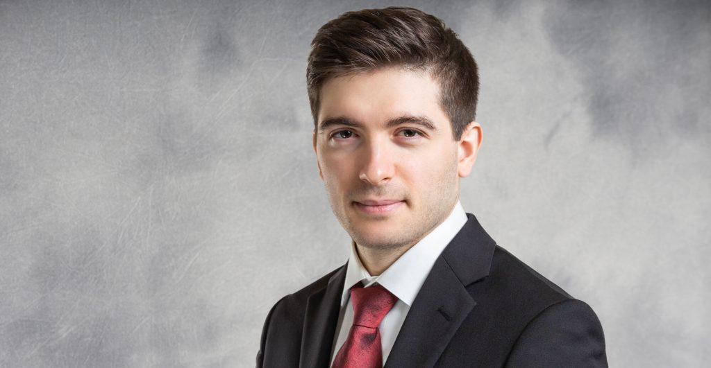 Man in suit with red tie.