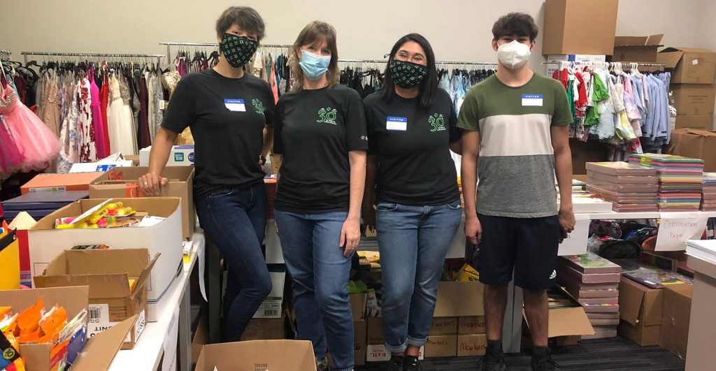 Volunteers organizing school supplies donation.