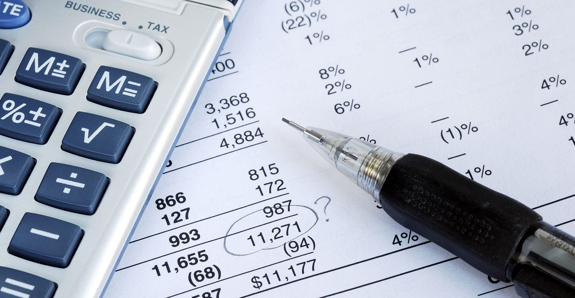 Calculator and pen on financial documents