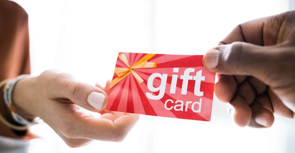 Handing over a gift card.