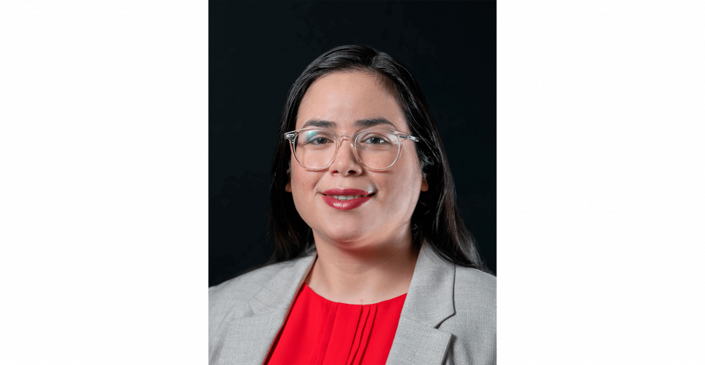 Person in professional attire, red top.