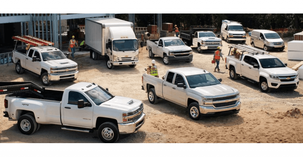 Various white trucks at construction site