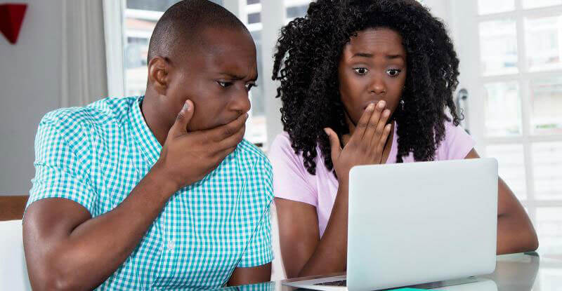Two people looking at a laptop.
