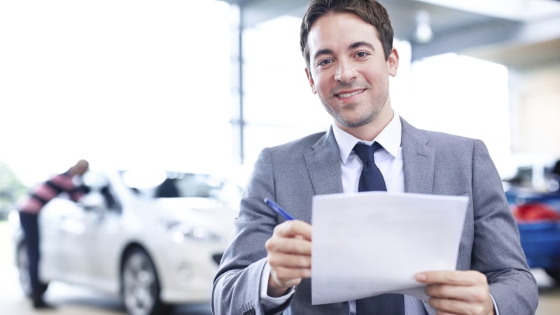 Man in suit holding paperwork