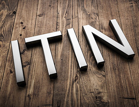 Metallic letters spelling 'ITIN'