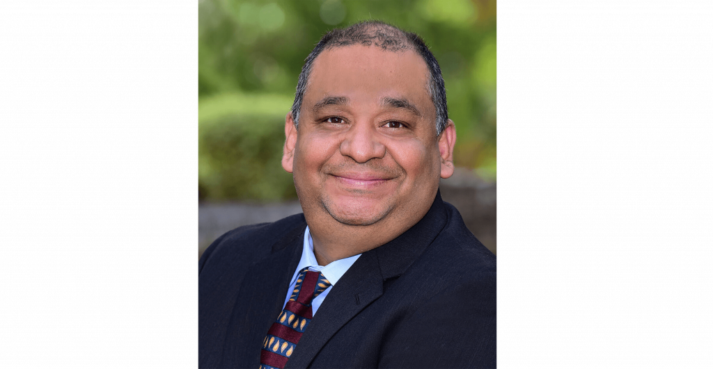 Man in suit with patterned tie.