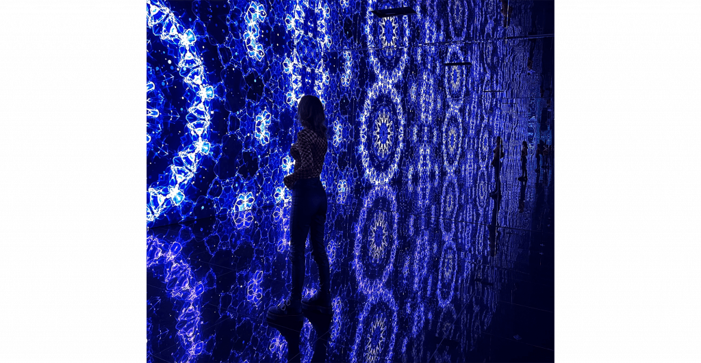 Person silhouetted against blue patterns