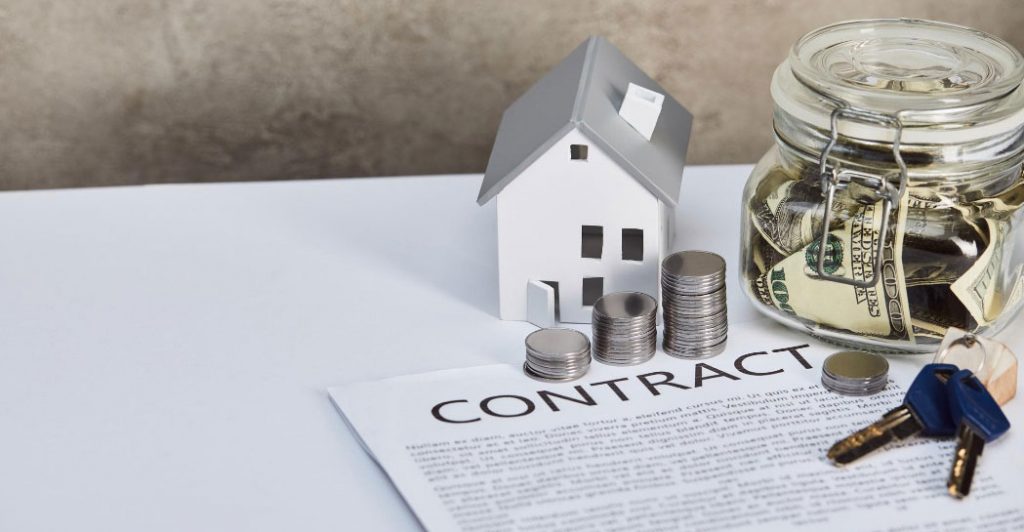 House model, coins, contract, keys.