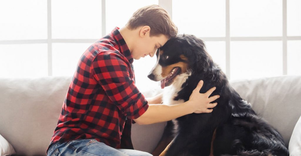 Person and dog sharing a moment.