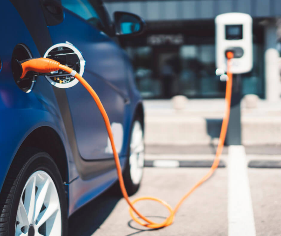 Electric vehicle charging at station.
