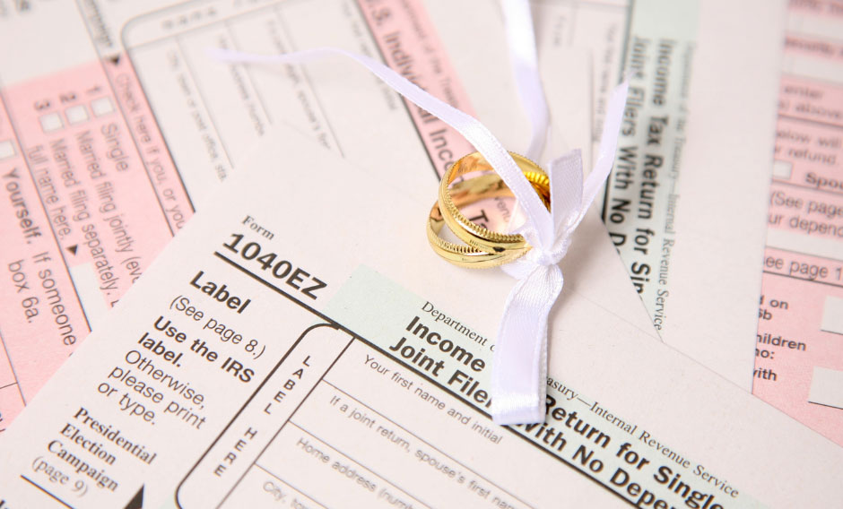 Tax forms with wedding ring decoration