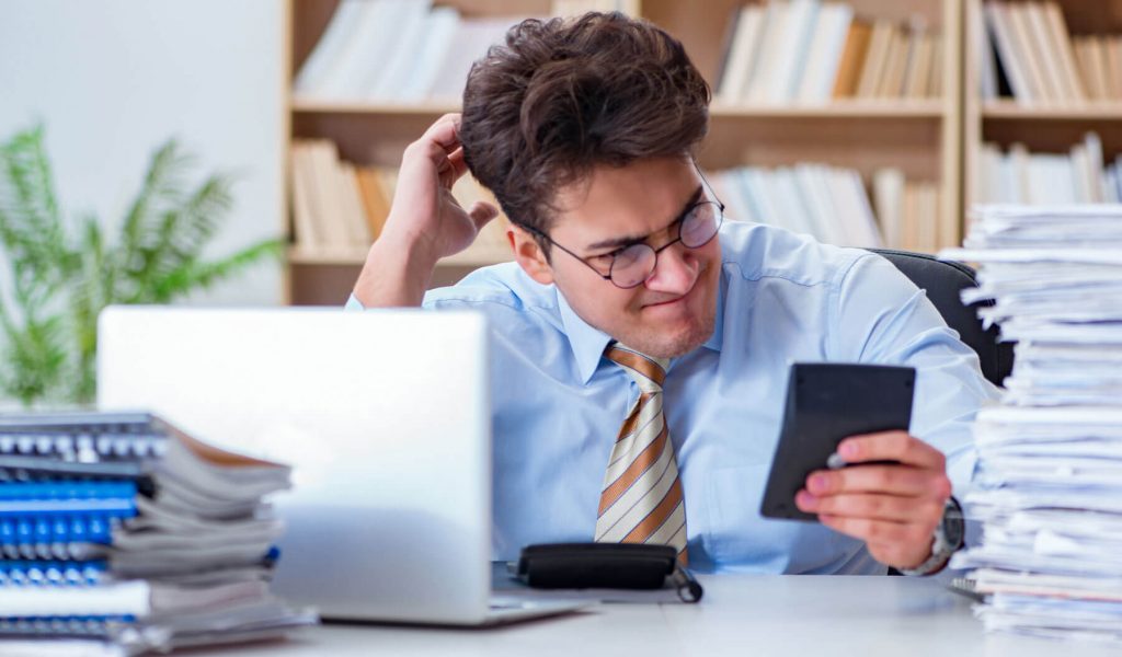 Person looking at phone in office.