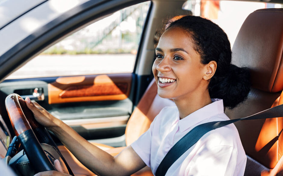 Person driving in a car interior.