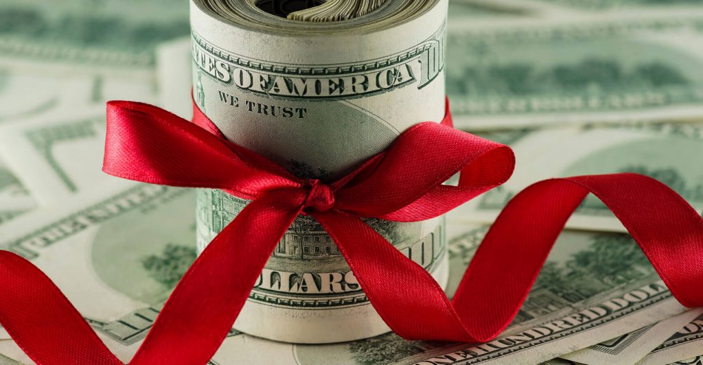 Money wrapped with a red ribbon