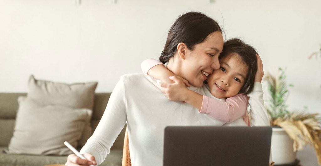 Parent working with child embracing