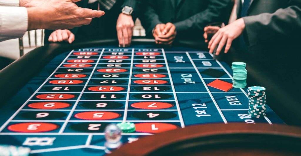 People playing roulette at casino table