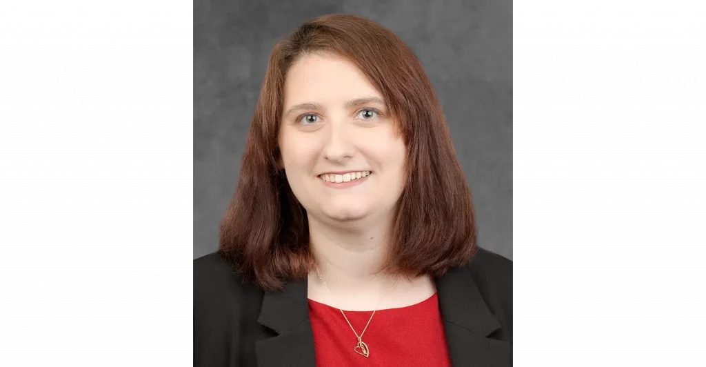 Woman in blazer with red top