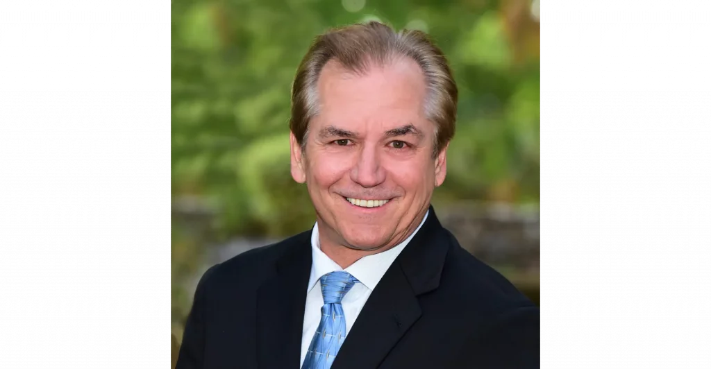 Man in suit with blue tie.
