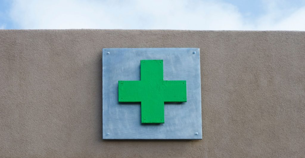 Green cross sign on wall