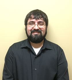 Person in black shirt, neutral background.