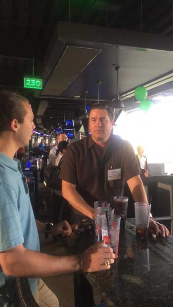 Two people conversing at a bar.