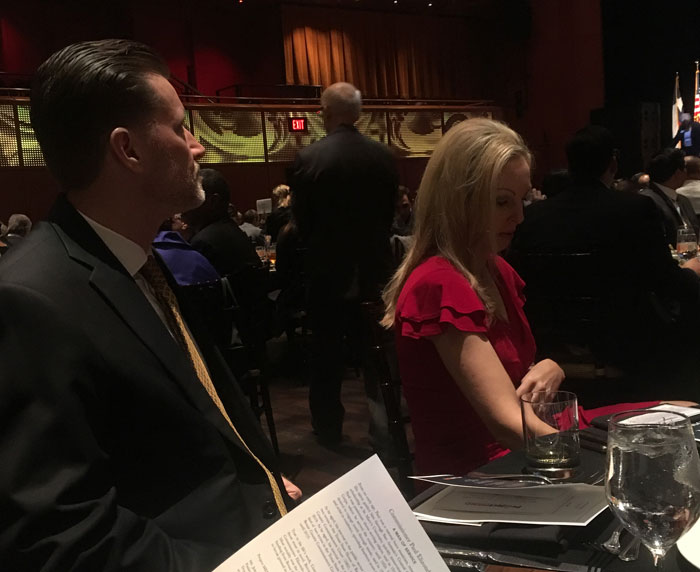 Elegant event with attendees at tables.