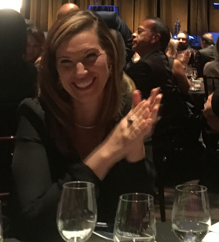 Applauding at a formal event.