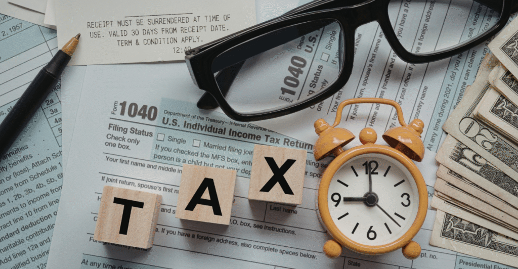 Tax documents with clock and glasses
